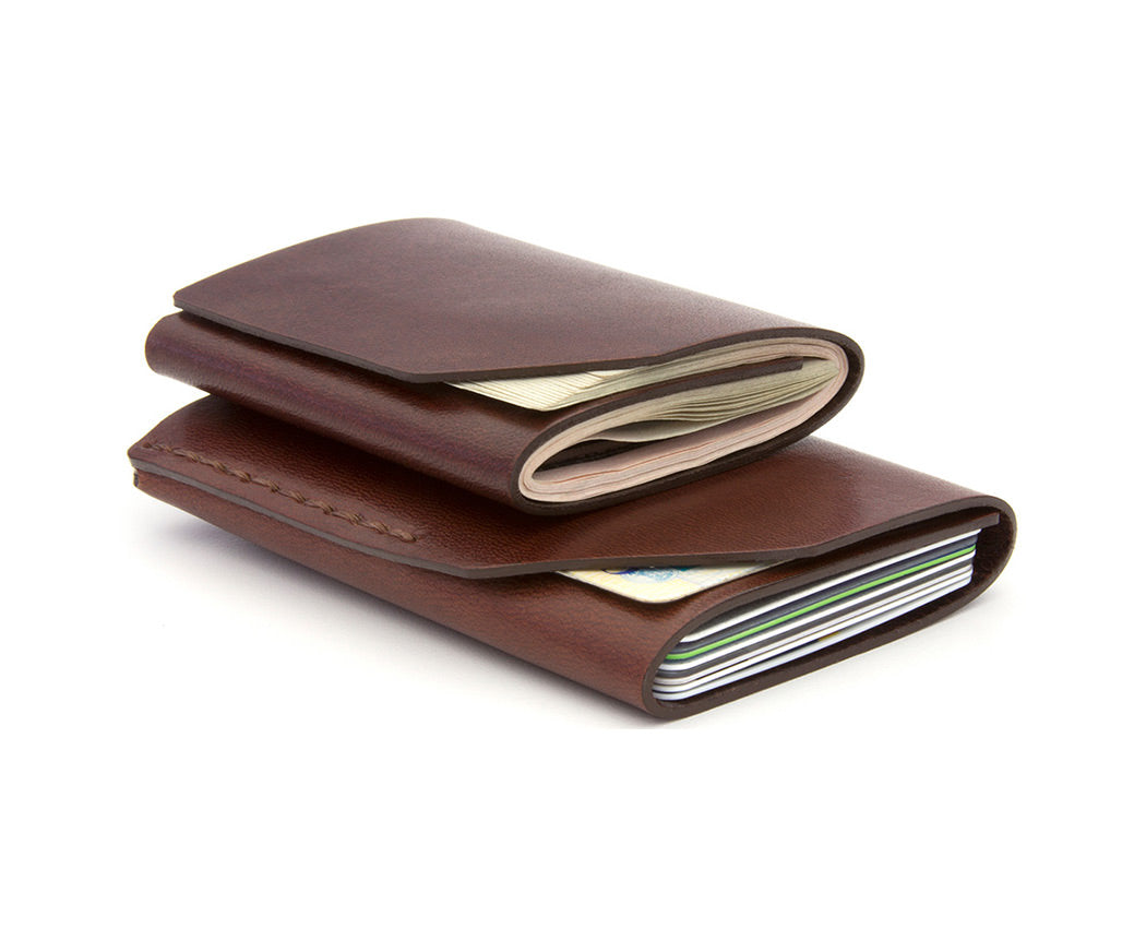 2 red-brown leather wallets on top of each other