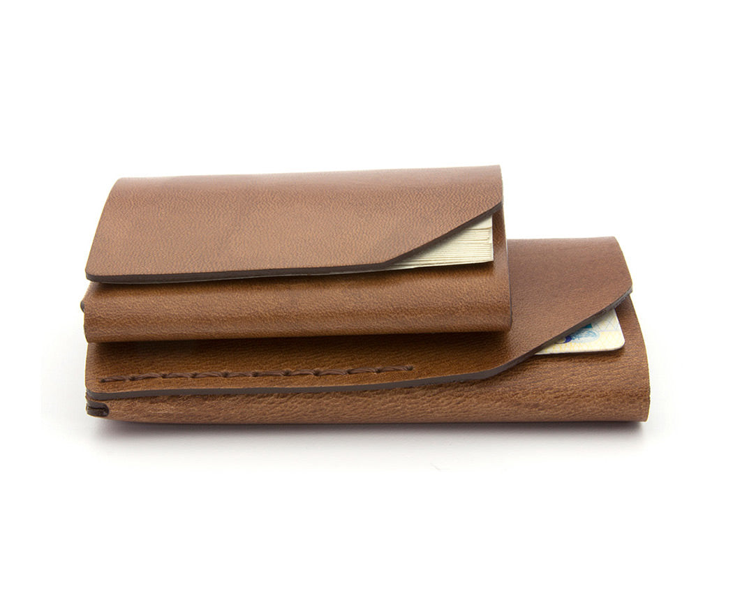 stacked brown leather wallets