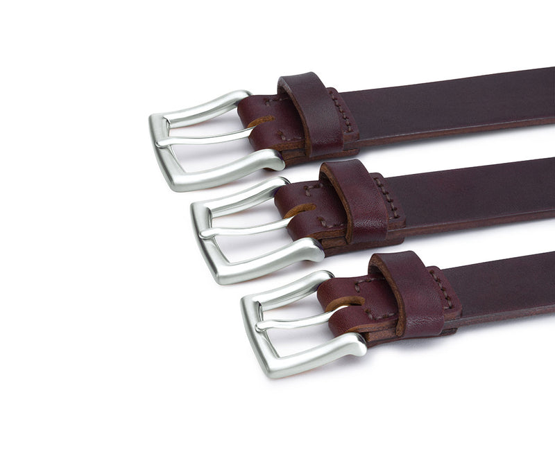 row of brown leather belts with silver buckles