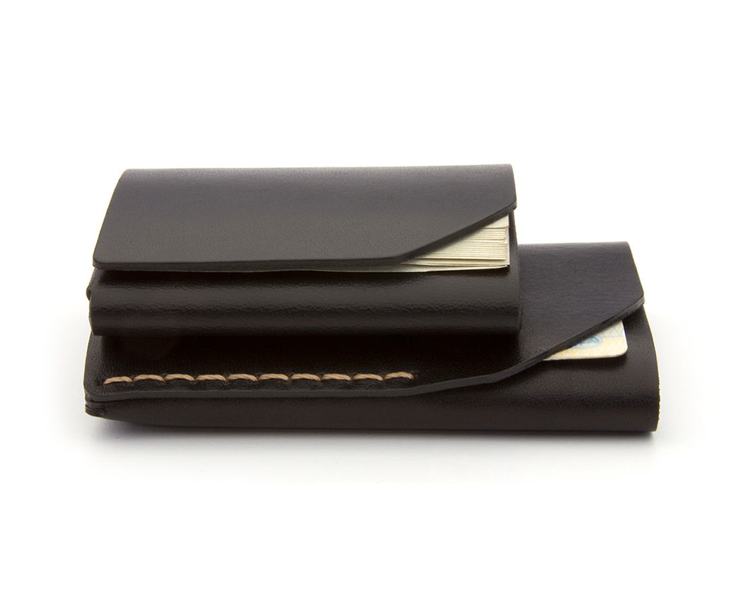 Stacked black leather wallets