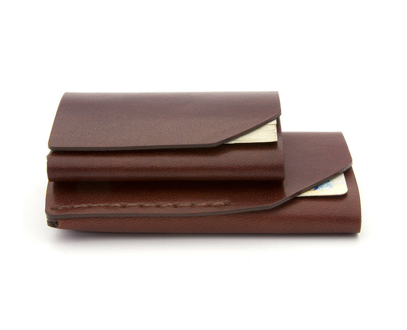 stacked reddish brown leather wallets