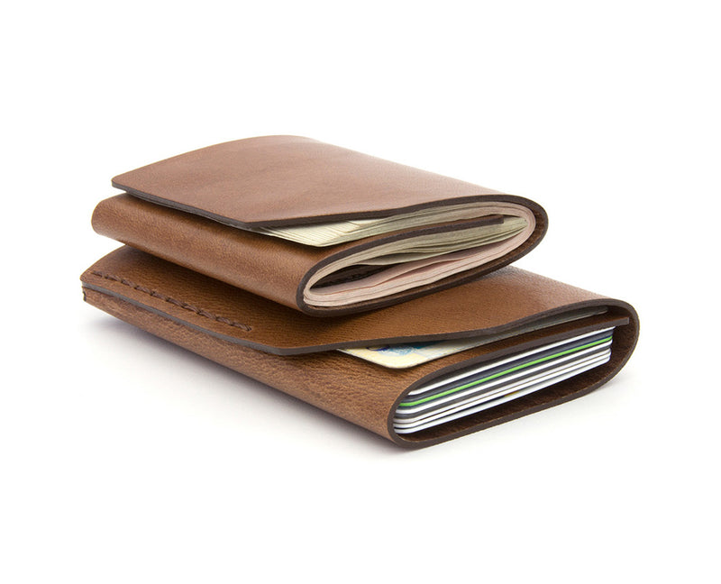 2 brown leather fold wallets stacked
