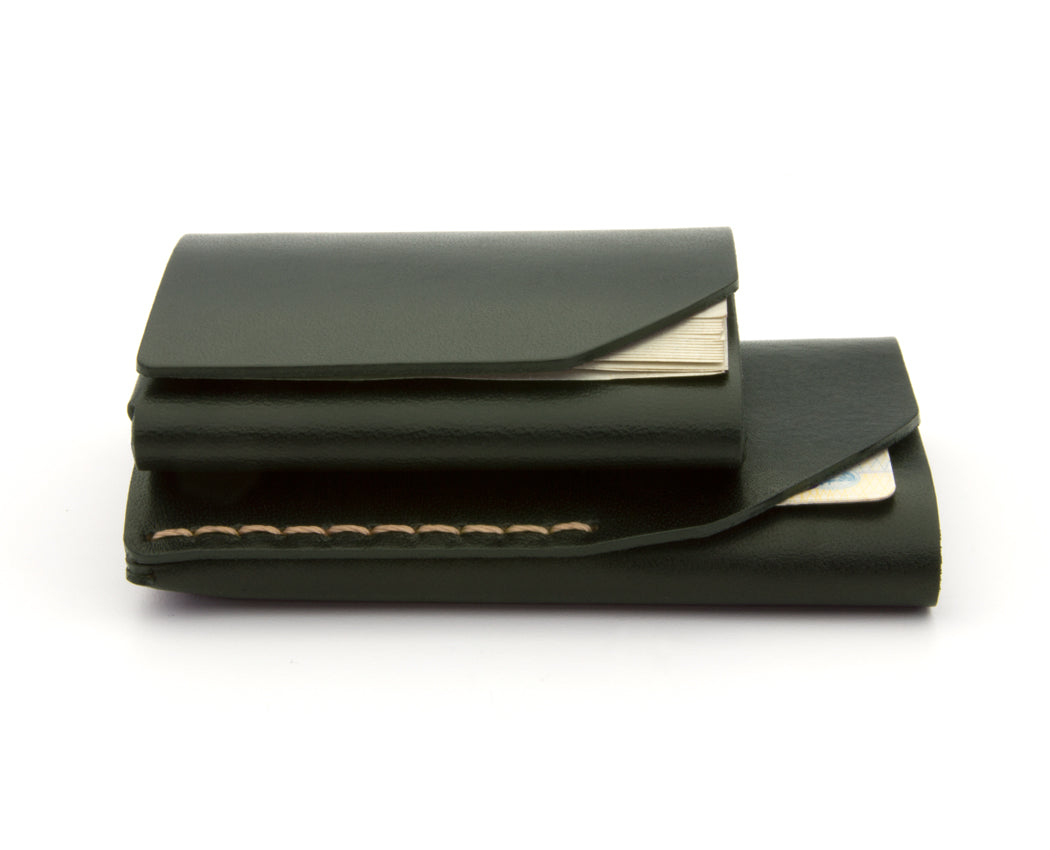 stacked green leather wallets